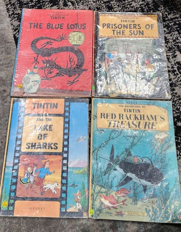 TinTin books x 4 - very collectible - used ex-library books (show wear/ writing in inside cover)